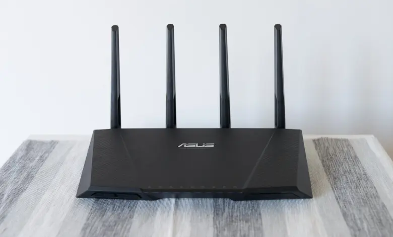 راوتر واي فاي من ASUS بأربعة هوائيات على طاولة