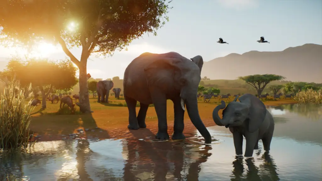 فيلان بالغ وصغير عند مجرى ماء في سافانا لعبة Planet Zoo 2